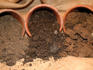 Sand, loam and clay soils spilling out of pots