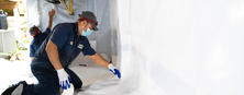 Dry Pro CFI applying vapor barrier to crawl space.