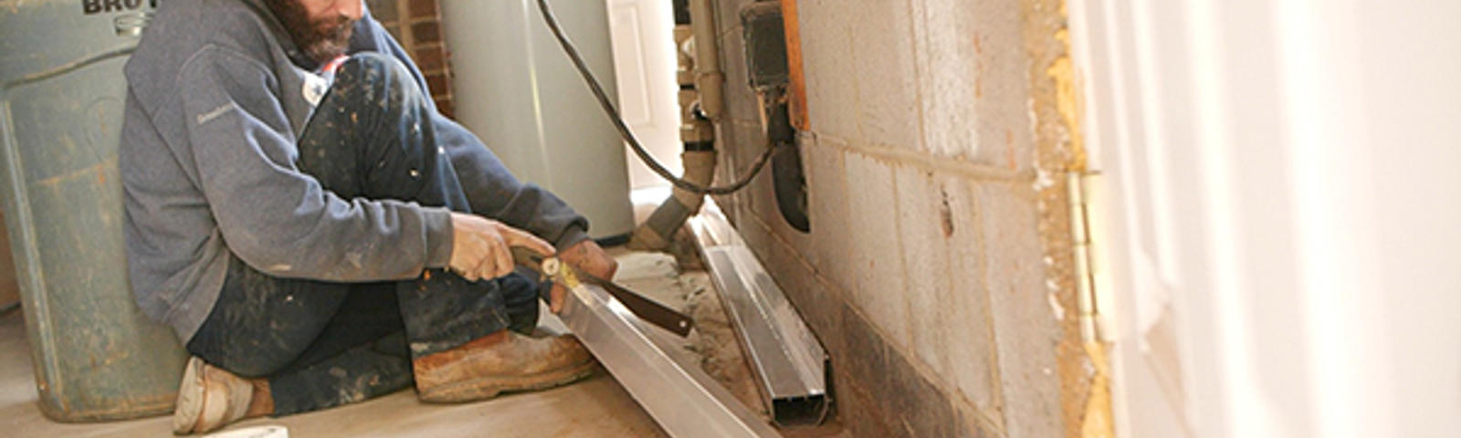 Dry Pro crew member installing interior drainage.