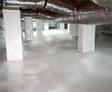 Crawl space with clean, white vapor barrier and insulated ducts running along the ceiling, showcasing how crawl space encapsulation can enhance home value.