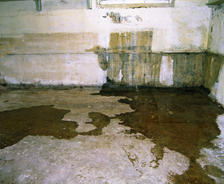 Basement walls with water leaking through cracks