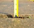 Measuring tape on cracked concrete before PolyRenewal injection