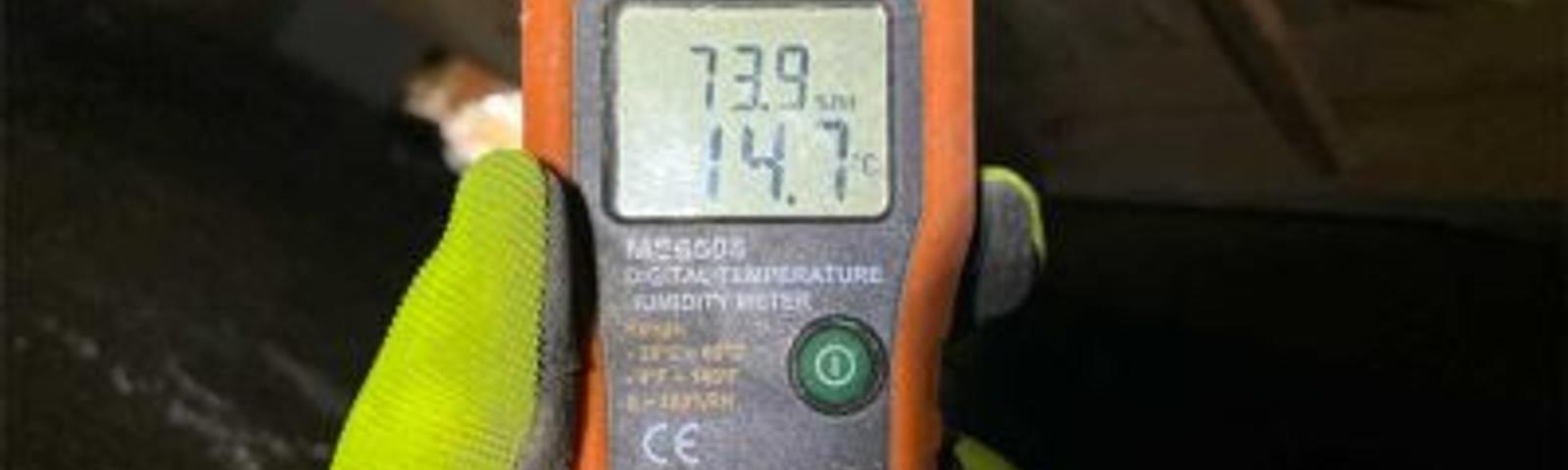 Certified Field Inspector performing crawl space inspection interior moisturemeter