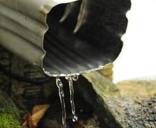 Water flowing from a gutter downspout