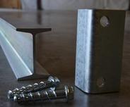 A metal I beam with bracket and two screws
