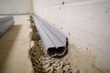Installed interior basement gutter french drain full perimeter solution