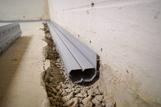 Installed interior basement gutter french drain full perimeter solution