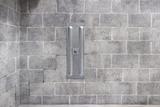 basement wall anchor installed on grey cinderblock wall