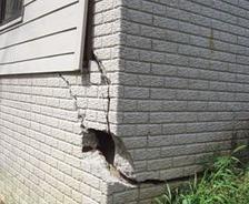 Severely cracked foundation on the exterior of the home