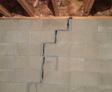 very bad crack in cement basement wall that is separating and threatening the structure of the home