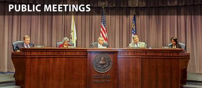 Four meeting at a table for a Cobb County public meeting