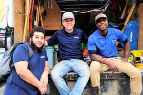 Three AquaGuard production team members in blue shirts