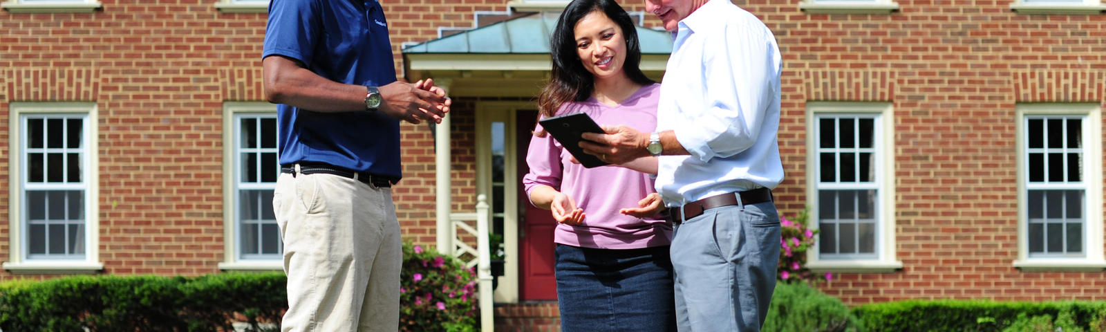 Certified Field Inspector outside with homeowners