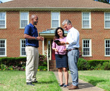 Certified Field Inspector outside with homeowners