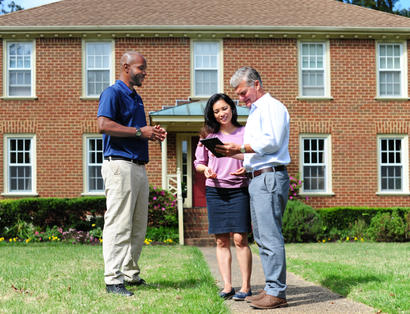 Certified Field Inspector outside with homeowners