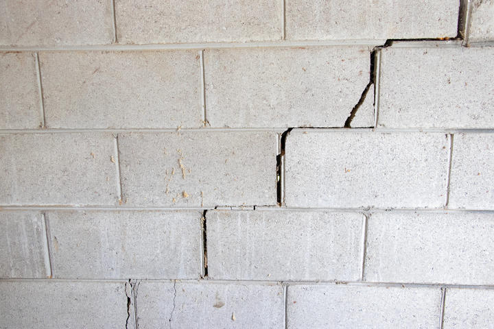 Cinder block wall with stair step cracks