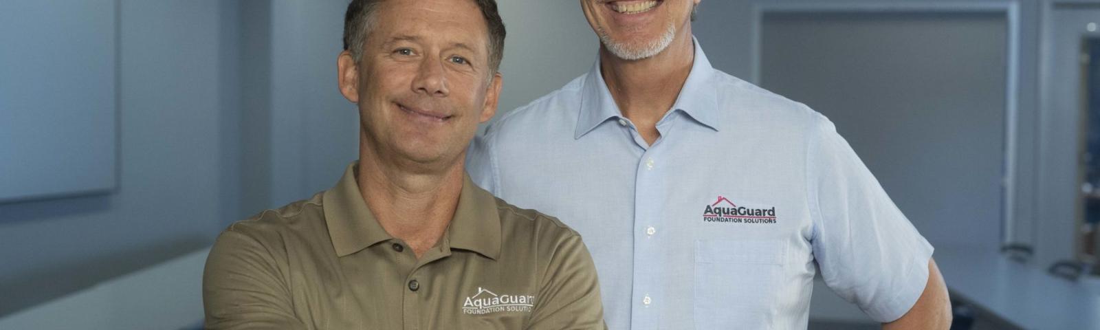 Two men standing in a room
