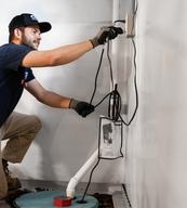 AquaGuard technician performing basement waterproofing