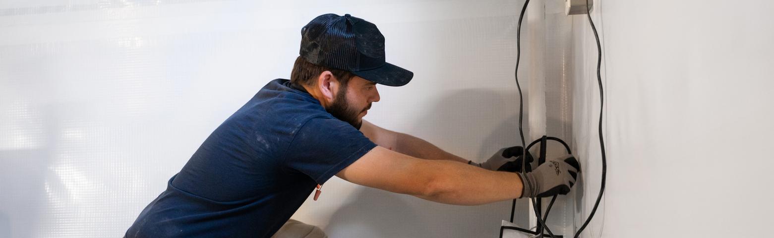 AquaGuard technician performing basement waterproofing