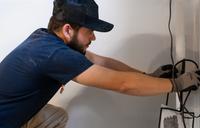 AquaGuard technician performing basement waterproofing