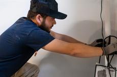 AquaGuard technician performing basement waterproofing