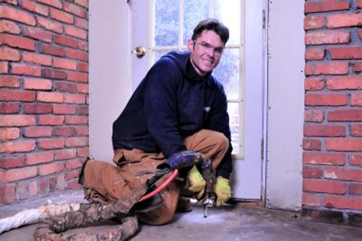 Man injecting PolyRenewal into concrete
