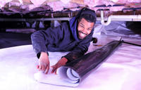 Man installing CrawlSeal Crawl Space Vapor Barrier