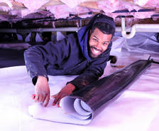 Man installing CrawlSeal Crawl Space Vapor Barrier