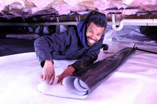 Man installing CrawlSeal Crawl Space Vapor Barrier