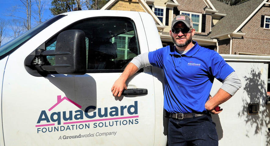 AquaGuard crew member in front of truck