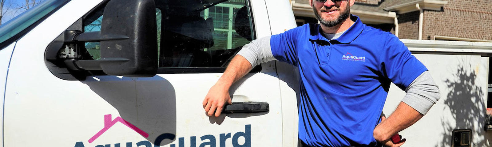 AquaGuard crew member in front of truck