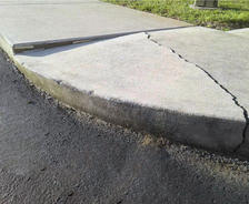 Concrete sidewalk that is severely cracked
