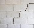 Cinder block wall with stair step cracks