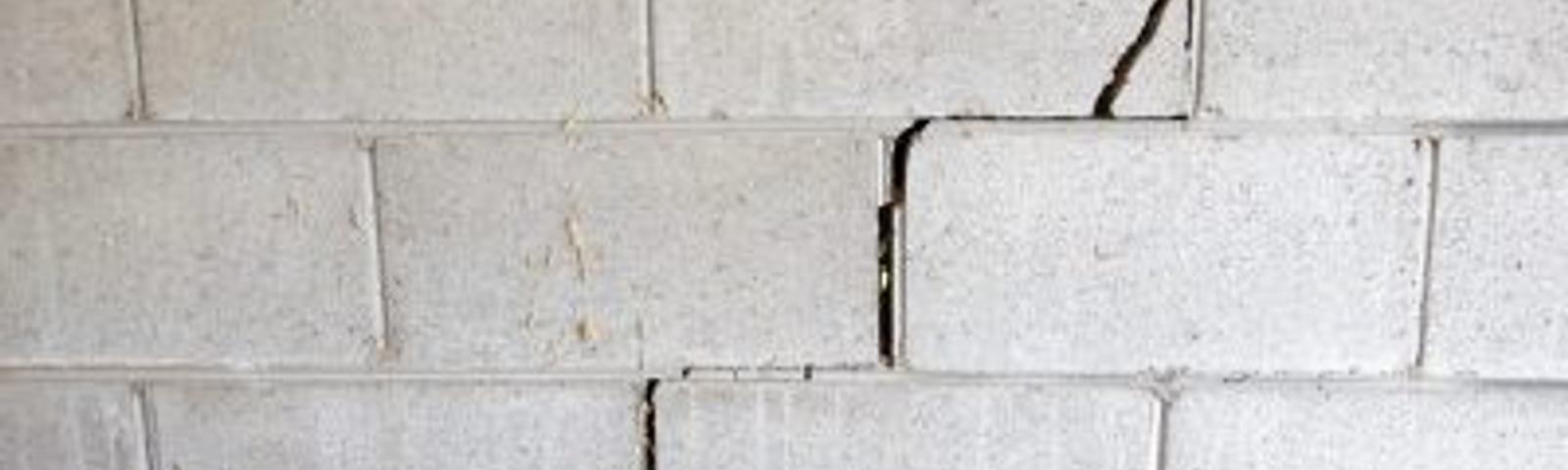 Cinder block wall with stair step cracks