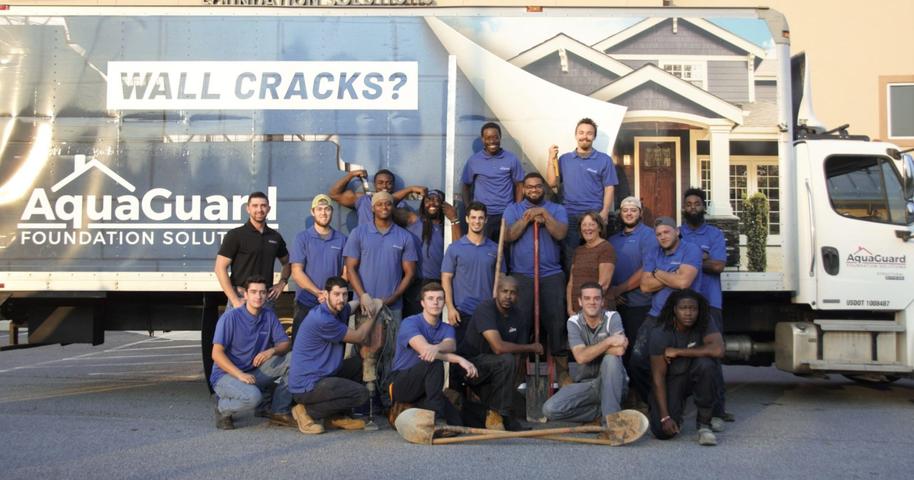 Aquaguard team standing in front of Aquaguard box truck