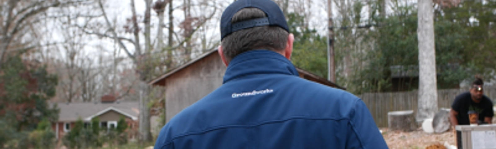 Back of man in Groundwork jacket and hat