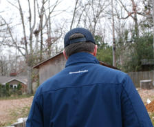 Back of man in Groundwork jacket and hat