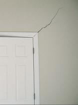 interior drywall crack near door