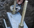 Crew member tightening pier screws