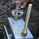 Crew member tightening pier screws