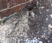 Soil Erosion against brick house