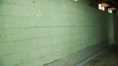Horizontal basement wall crack on white cinder block walls