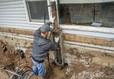 Man Installing SettleStop Pier System