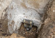 The footing of of a push pier in place at the foundation of a home