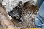 A push pier being installed at the foundation of a house