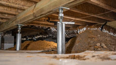 IntelliJack Crawl Space Support Jacks in place under the floor joists of an Atlanta resident's home