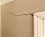 Interior drywall crack by doorway