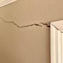 Interior drywall crack by doorway