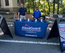 AquaGuard employees stand at a company booth at the 2026 Taste of Alpharetta food festival