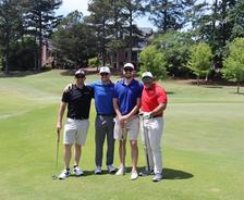 AquaGuard employees stand on a golf course during the 31st Annual Red Jacket Golf Classic